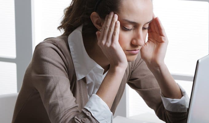 woman at work with headache